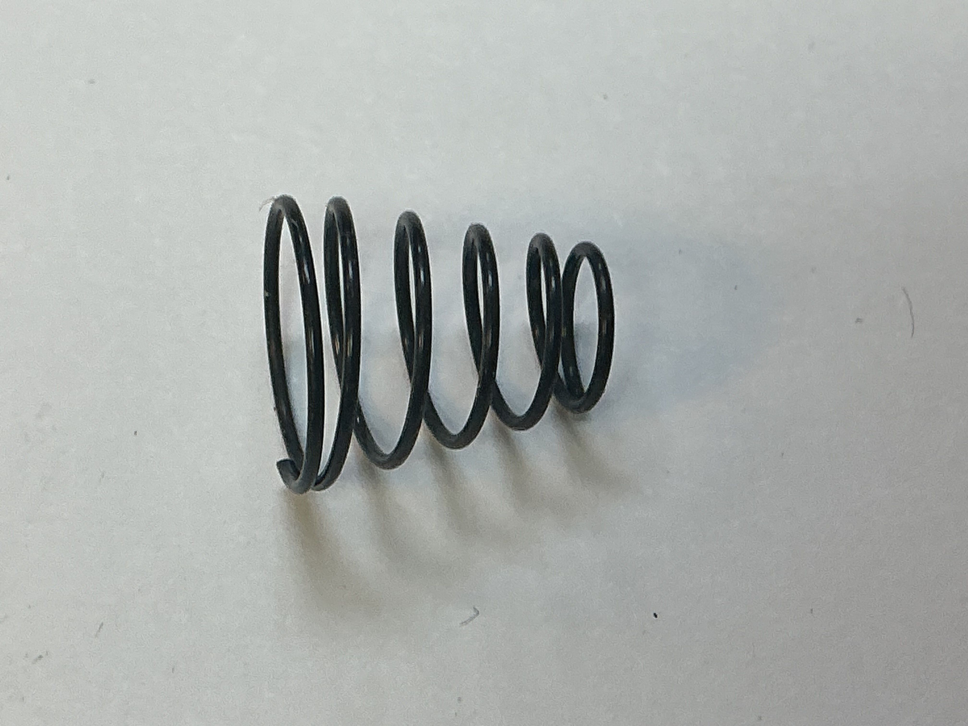 SPRING / CONICAL / 7.7mm D (TOP) x 12.8mm D (BOTTOM) x 13.2mm LONG / 0.7mm THICK WIRE / BLACK